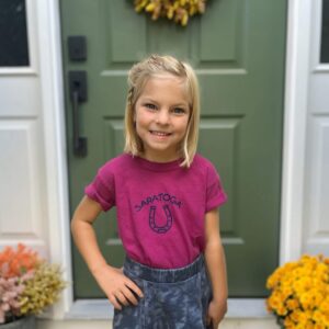 Boysenberry colored t-shirt-short sleeve-horseshoe on chest- Saratoga above-worn by a girl