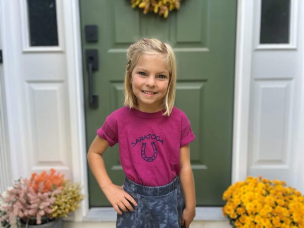 Boysenberry colored t-shirt-short sleeve-horseshoe on chest- Saratoga above-worn by a girl