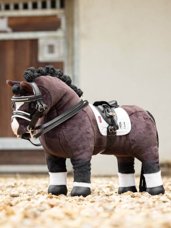 black dressage saddle on horse